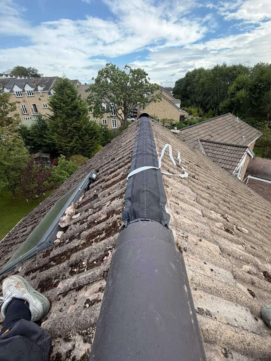 Finished dry ridge system along a tiled roof