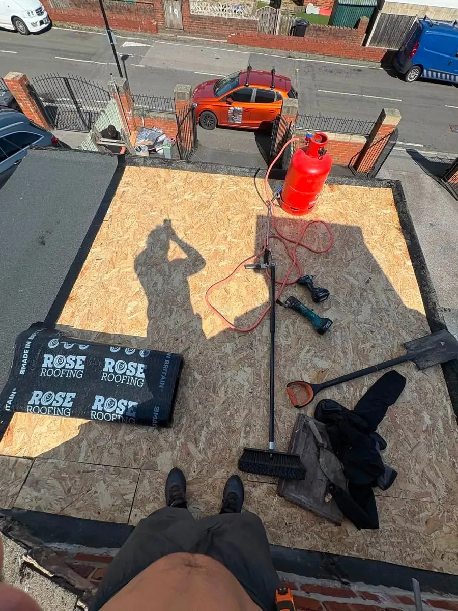 Flat roof deck being prepared for roofing work